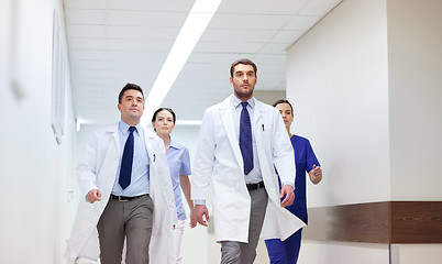 Image showing group of medics walking along hospital