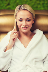 Image showing beautiful young woman with smartphone at spa