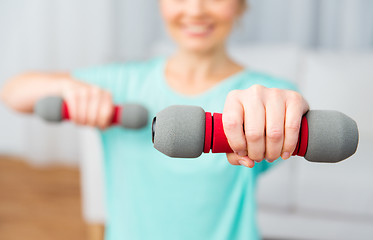 Image showing close up of woman exercising with dumbbell at home