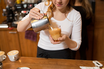 Image showing close up of woman making coffee at shop or cafe