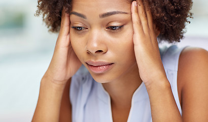 Image showing close up of african young woman touching her head