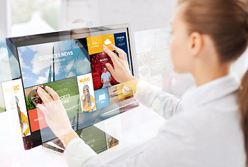 Image showing woman with web pages on touchscreen in office