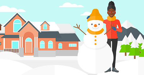Image showing Woman posing near snowman.