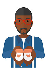 Image showing Man holding baby booties.