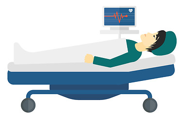 Image showing Patient lying in bed with heart monitor.