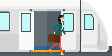 Image showing Woman going out of train.