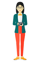 Image showing Smiling photographer holding camera.