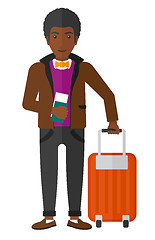 Image showing Man standing with suitcase and holding ticket.