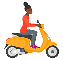 Image showing Woman riding scooter.