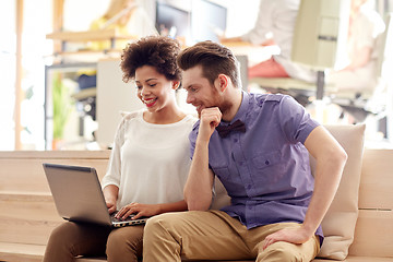 Image showing happy creative team with laptop in office