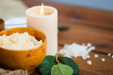 Image showing close up of natural body scrub and candle on wood