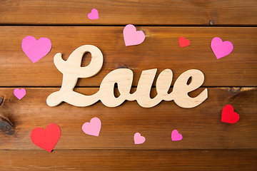 Image showing close up of word love with red paper hearts