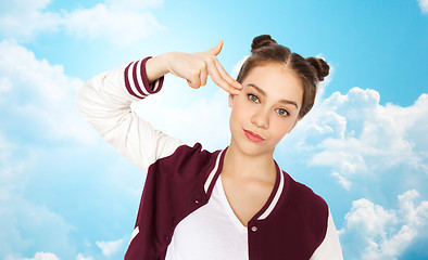 Image showing bored teenage girl making finger gun gesture