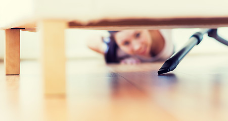 Image showing close up of woman with vacuum cleaner at home