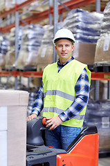 Image showing man on forklift loading boxes at warehouse