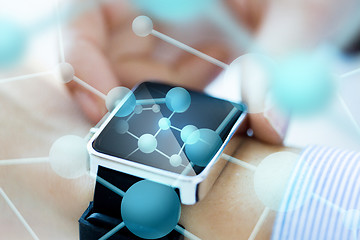 Image showing close up of hands with molecules on smartwatch