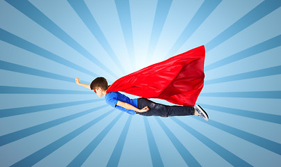 Image showing boy in red superhero cape and mask flying on air