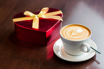 Image showing close up of gift box and coffee cup on table