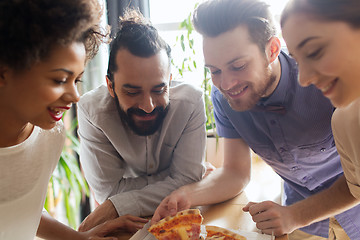 Image showing happy business team eating pizza in office