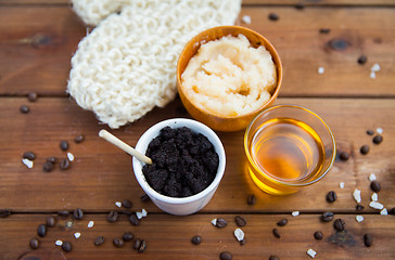 Image showing close up of coffee scrub in cup and honey on wood