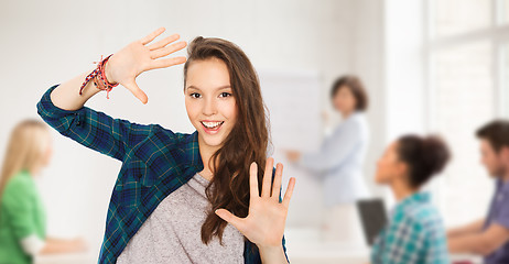 Image showing teenage student girl showing hands at school