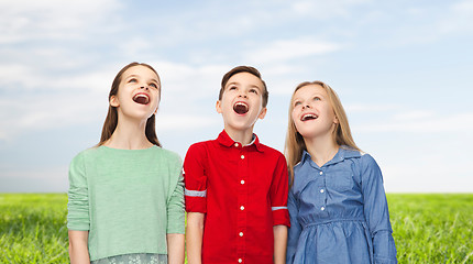 Image showing amazed boy and girls looking up