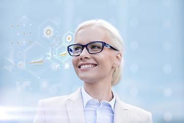 Image showing young smiling businesswoman in eyeglasses outdoors