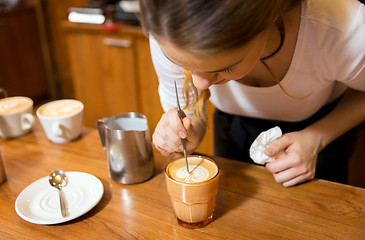 Image showing close up of woman making coffee at shop or cafe