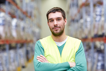 Image showing happy man in reflective safety vest at warehouse