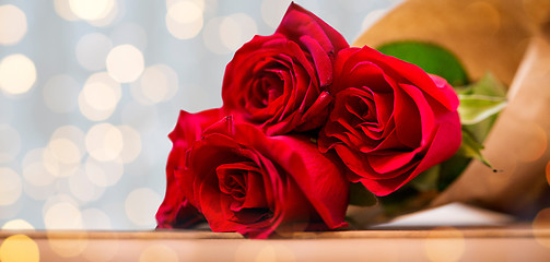 Image showing close up of red roses bunch wrapped into paper