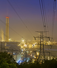 Image showing power station at night with smoke 