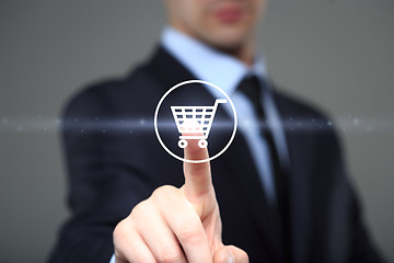 Image showing business, technology, internet and networking concept. businessman touching virtual shopping cart.