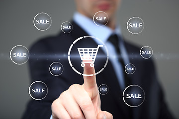 Image showing business, technology, internet and networking concept. businessman touching virtual shopping cart.