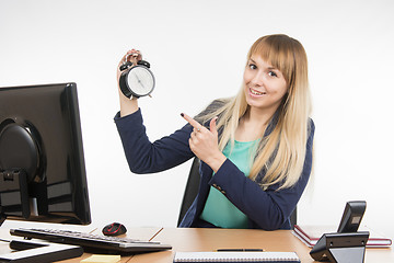 Image showing Office specialist in after-hours shows the clock