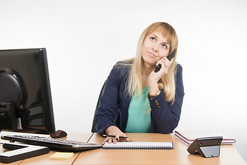 Image showing Angry business woman talking on the phone and looking up