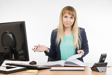 Image showing Indifferent office a specialist office leafing through a book