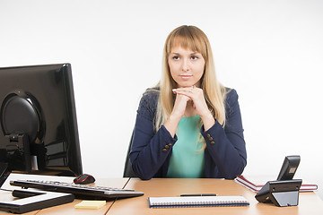 Image showing Strict office a specialist sitting at a desk and looking at visitor