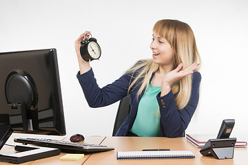 Image showing  Office saw a specialist on the clock that the working day is finished