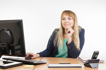 Image showing The friendly girl looked up at the office visitor