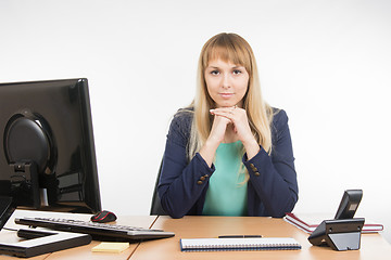 Image showing Strict head sitting at a desk
