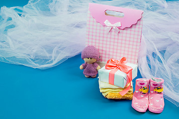 Image showing The baby clothes with a  white gift box