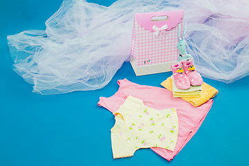 Image showing The baby clothes with a  gift box