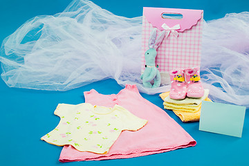 Image showing The baby clothes with a  gift box