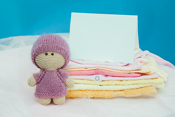 Image showing The baby clothes with card