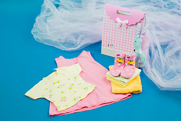 Image showing The baby clothes with a  gift box