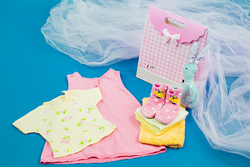 Image showing The baby clothes with a  gift box