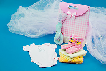 Image showing The baby clothes with a  white gift box