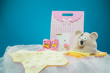 Image showing The baby clothes with a  gift box