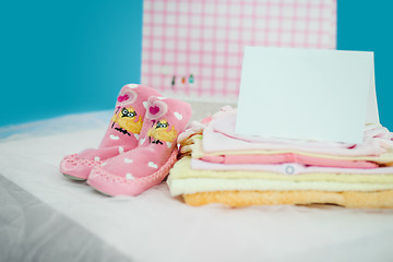 Image showing The baby clothes with card