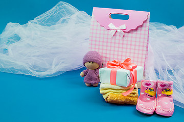 Image showing The baby clothes with a  white gift box